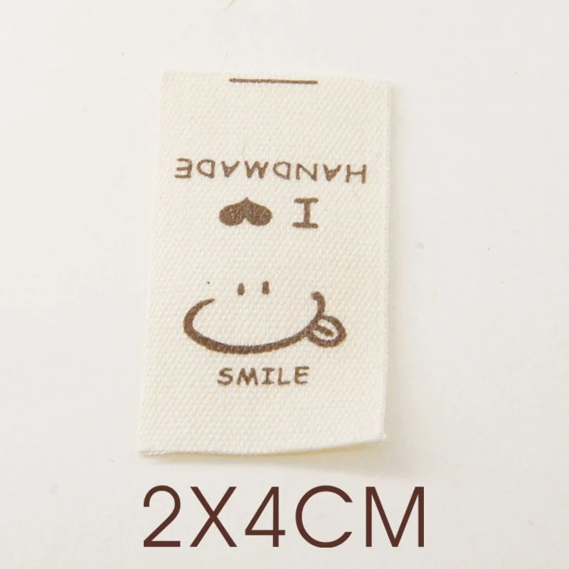 Hand-folded spot shipping mark head tulip bouquet smiling face cloth label accessories sewing DIY side label.