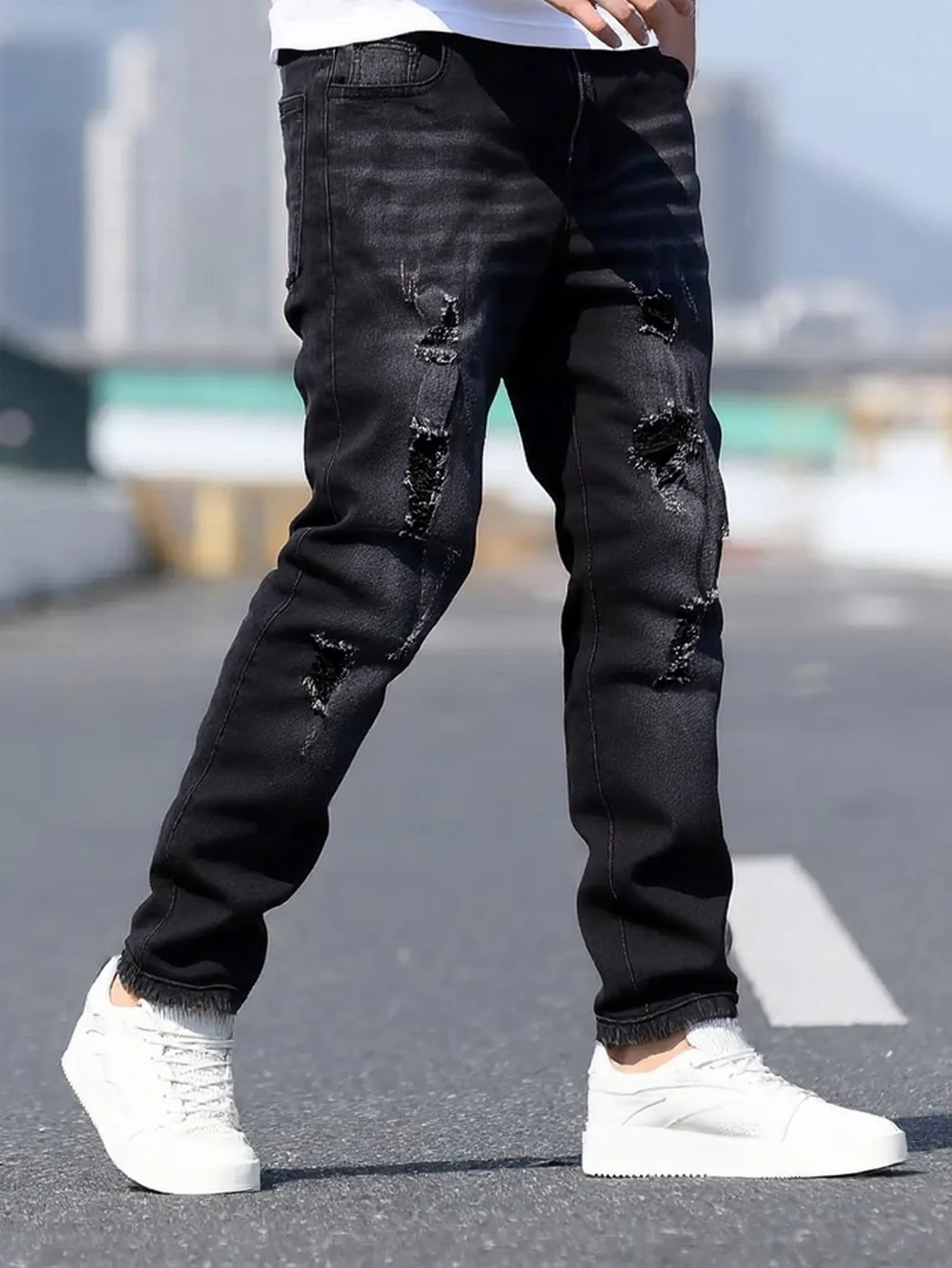 

Men's black and gray distressed jeans, featuring a unique worn-out design, loose fit, and versatile style, effortlessly creating