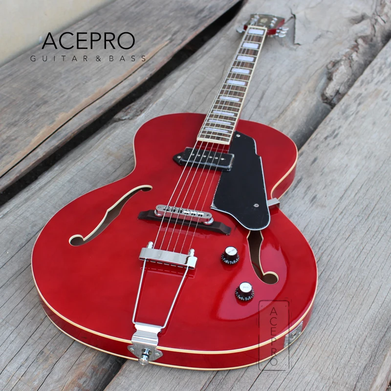 

Электрогитара Grote с прозрачным красным корпусом из клёна, полыми F-отверстиями, звукоснимателями P90, арчтоп-гитара