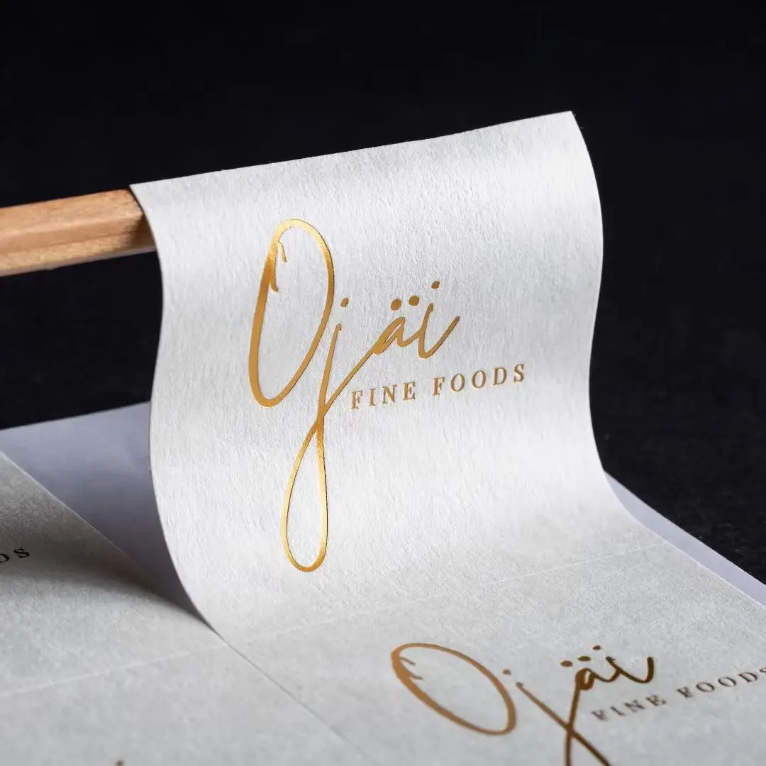 Luxury Packaging Label: Custom Textured Paper Sticker with Gold Foil Stamped Black Logo