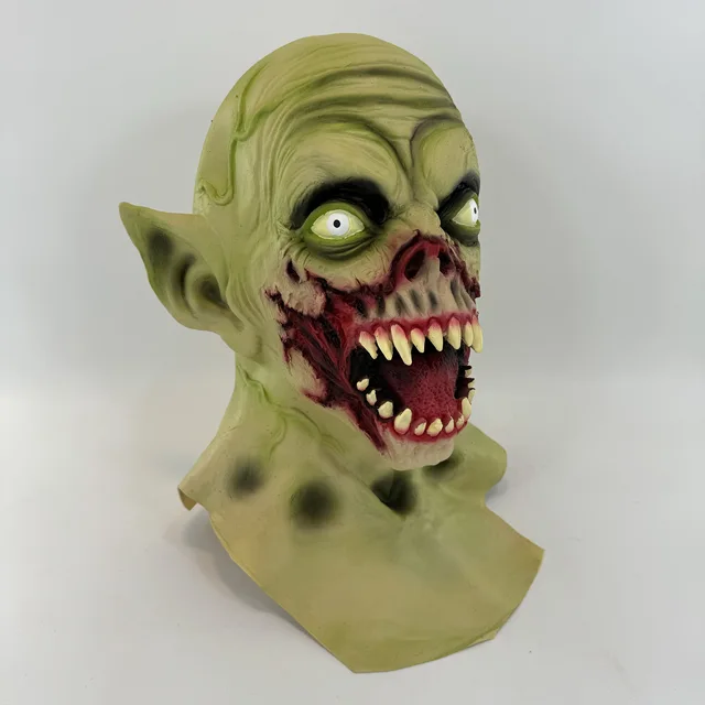 Scary green zombie Halloween mask with pointed ears, sharp teeth and horror face design