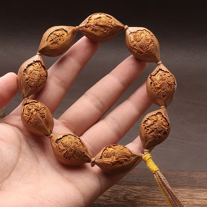 Original olive pit carving , depicting a deity descending from heaven, a gathering of immortals, a bracelet for playing