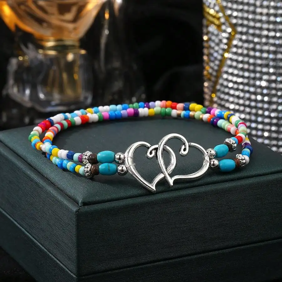 

Vibrant Multi-Color Beaded Layered Anklet With Interwoven Silver Double Heart Charm, Boho Summer Beach Foot Jewelry For Women