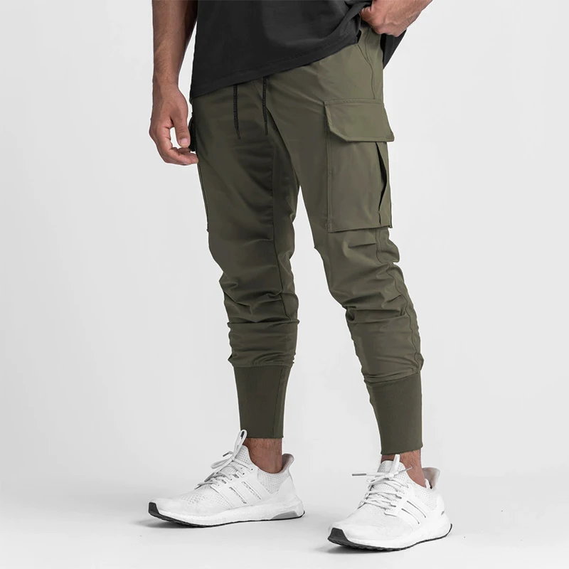 Pantalones deportivos elásticos de secado rápido para hombre, pantalones de entrenamiento deportivos finos y sueltos con bolsillos, ropa de trabajo, diseño 2025