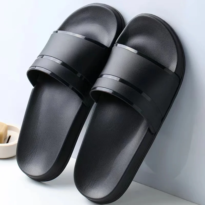 Large size slippers for men in hotels and guesthouses. Summer indoor minimalism, stay at home, take a shower in the bathroom, an