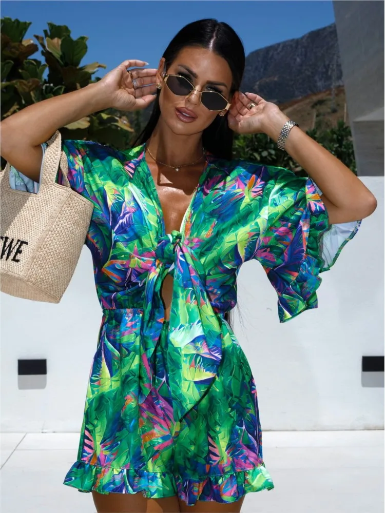 Fashion liburan motif bunga Playsuit Ruffles Patchwork lengan suar Hollow Lace-up Jumpsuit untuk wanita 2024 musim panas Romper pantai