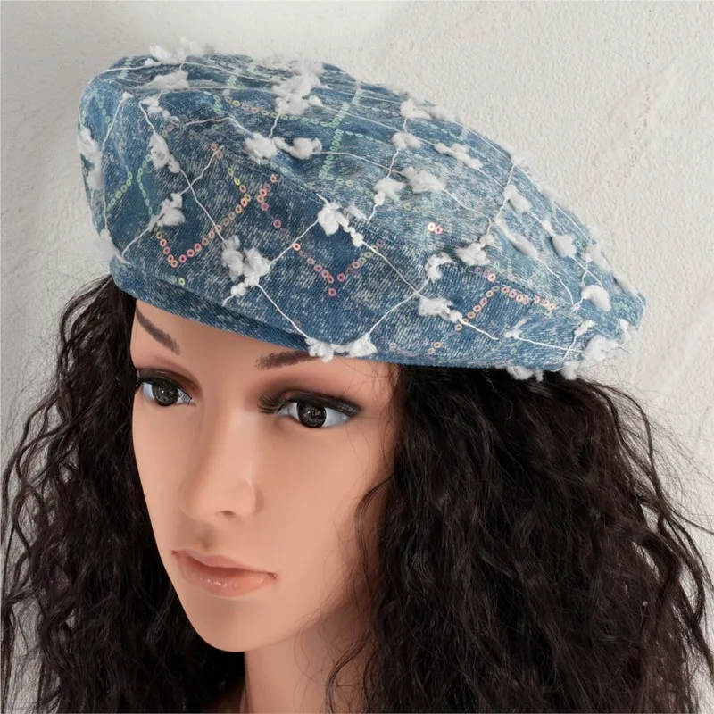 A lady's light blue washed beret with glittering sequined cotton is worn daily shopping