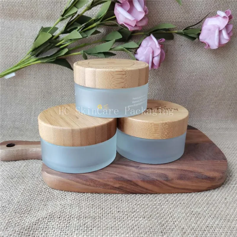 

Eco friendly cosmetic packaging eye cream hand cream jar matte glass jar with bamboo wood cap lid empty face cream jar wholesale