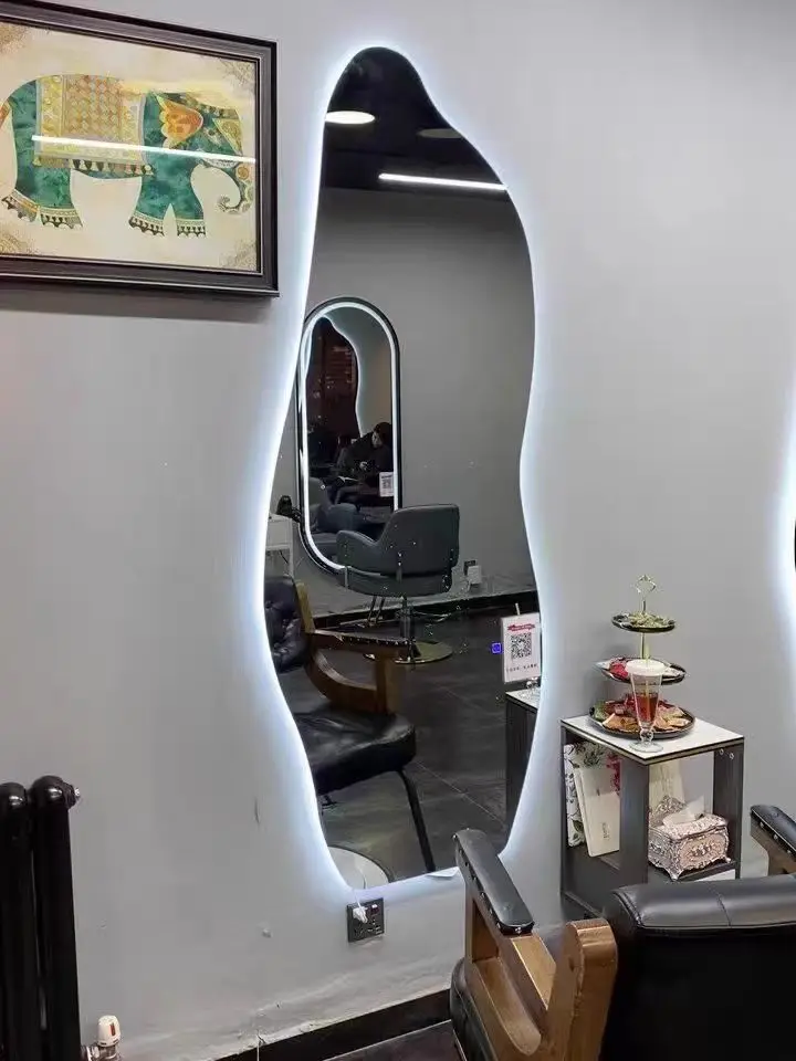 Single sided minimalist haircut with irregular mirror hanging on the wall and dedicated light for hair salons