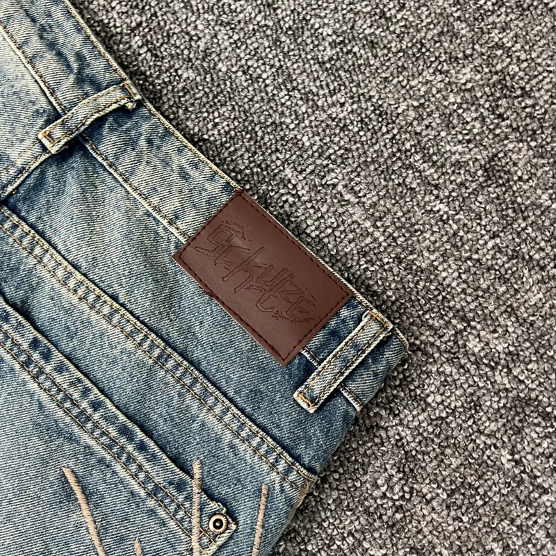 صور حقيقية Derschutze Street Retro Do Old Ripped Jeans التطريز الإلهي تمثال فضفاض عادية مستقيم الساق السراويل الرجال النساء