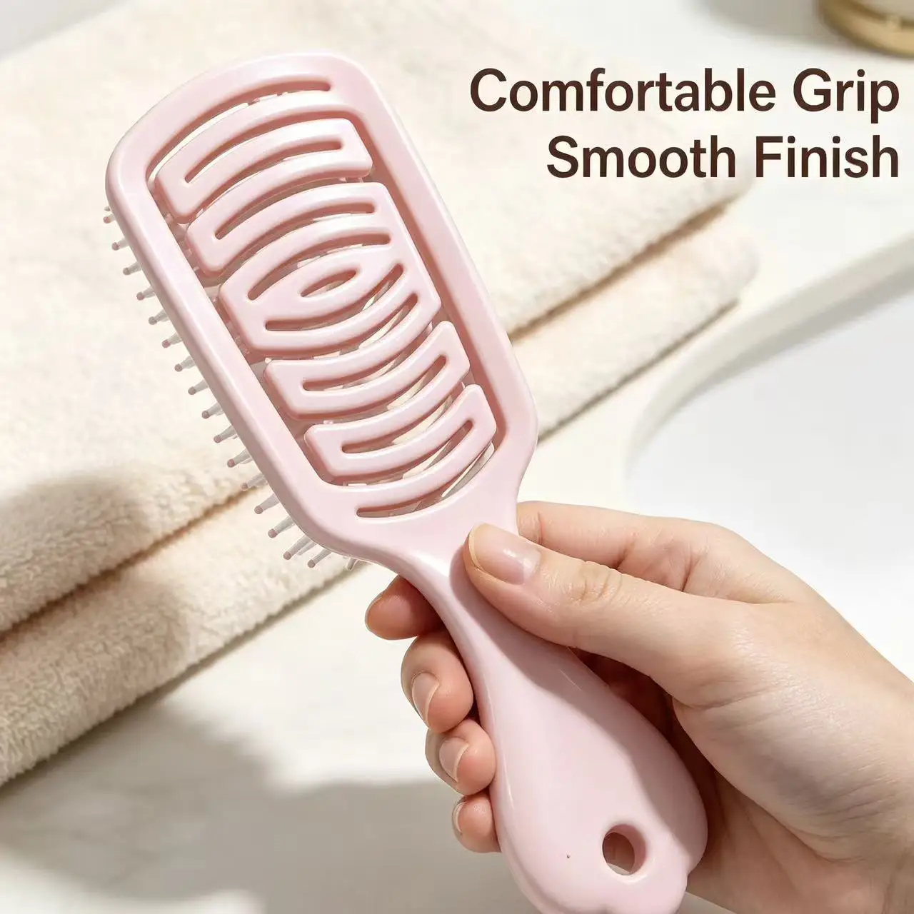 Pink perforated long-handled smooth hair comb, featuring breathable holes for quick drying, with rounded and soft comb teeth.