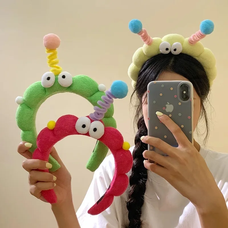 A cute girl's plush hair band with big eyes and curly hair a quirky and twisty hairpin hair accessory for selfies wholesale