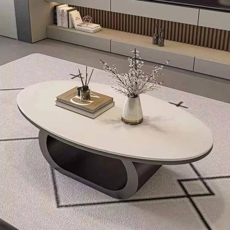 A modern oval coffee table with a sintered stone top and a unique hollow base for the living room