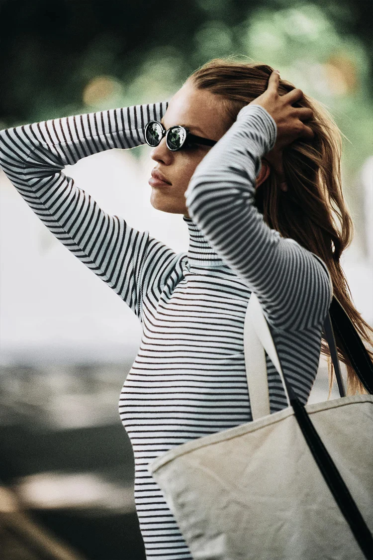 Frankies slim knit in blue and white stripes with turtleneck bottoms on the shoulders for a slimming look