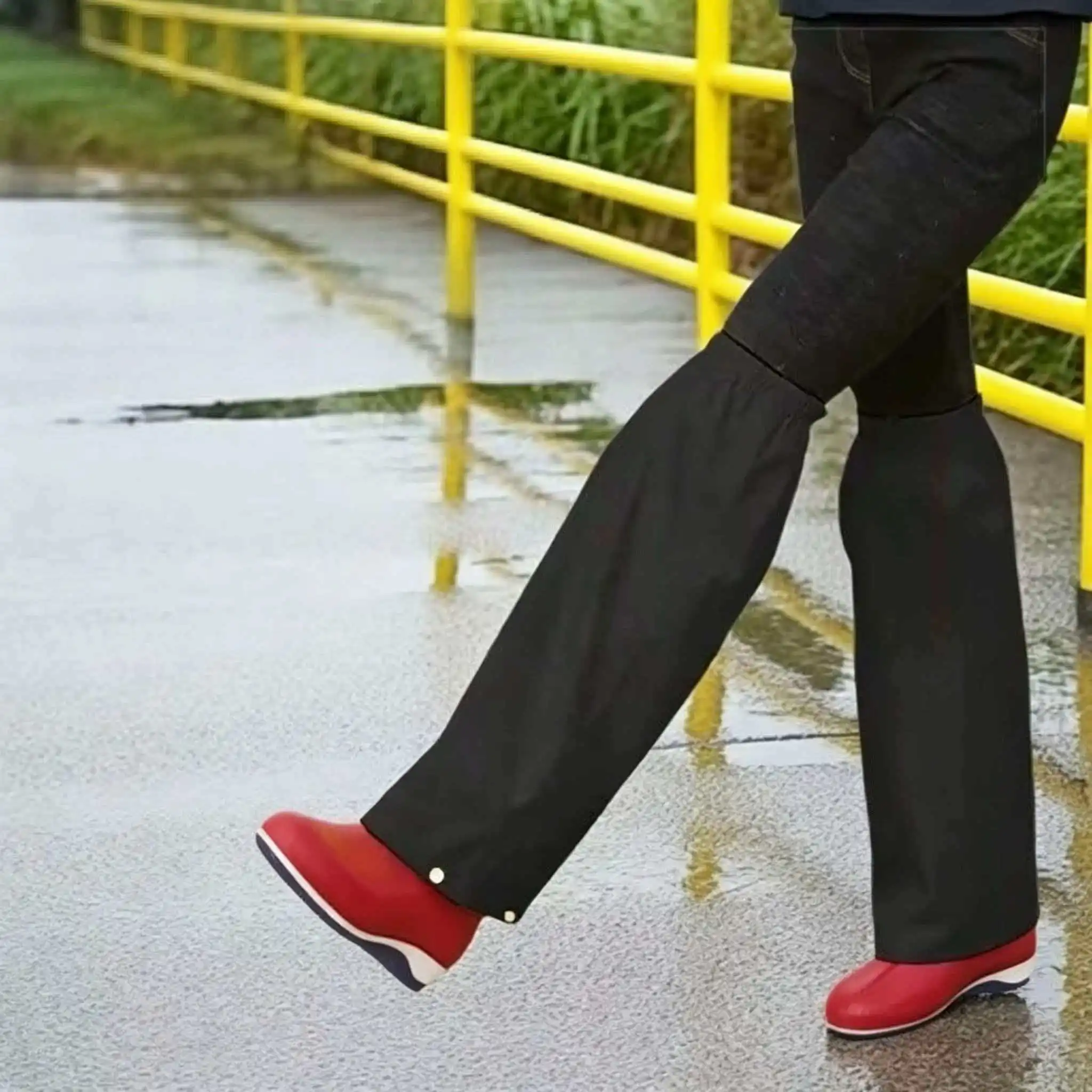 A pair of black leg warmers, elastic design, multiple sizes available, essential for cycling and hiking in the rain