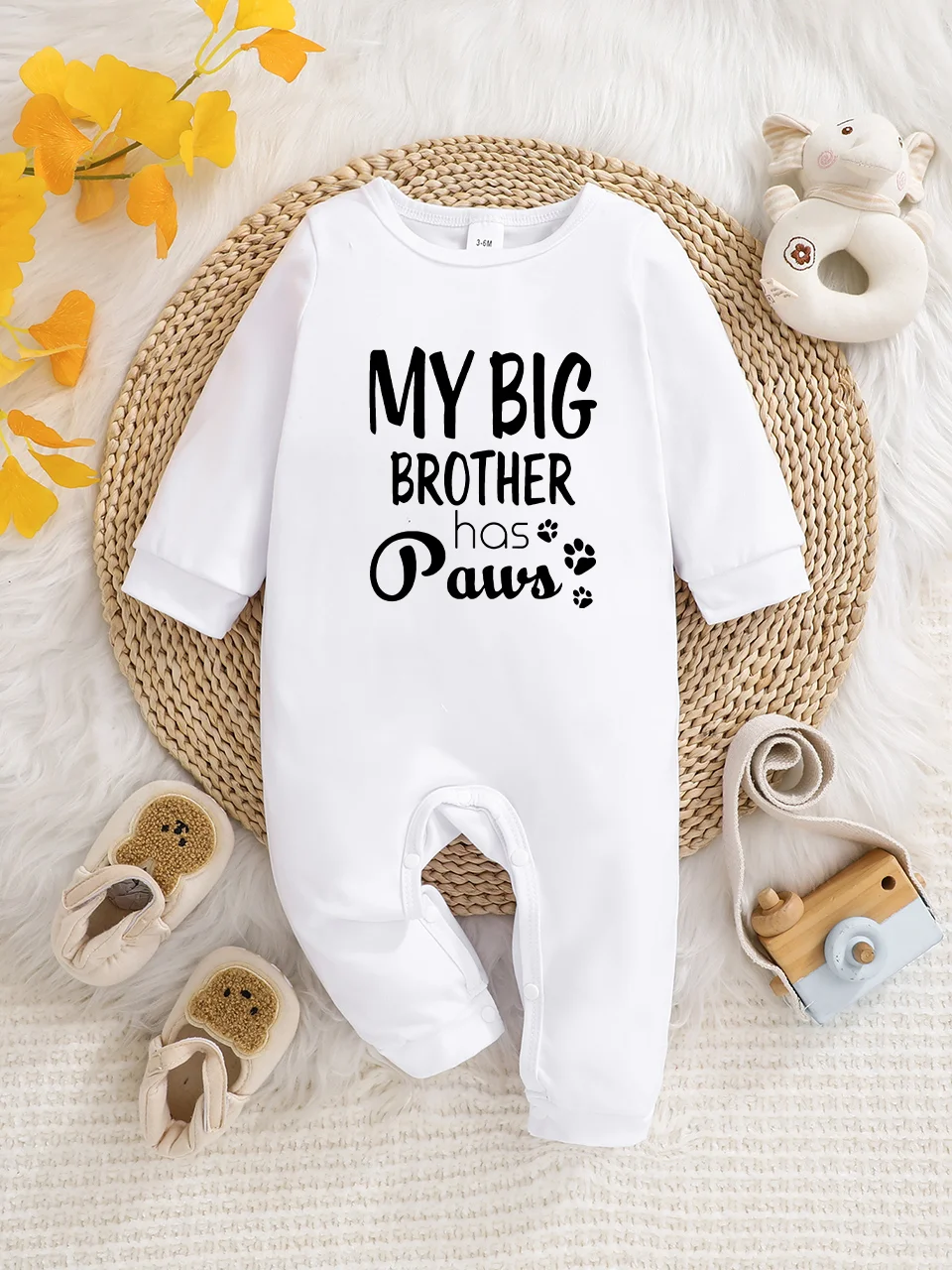 A baby long-sleeved onesie with interesting letter prints. It features a buttoned design for easy putting on and taking off, and