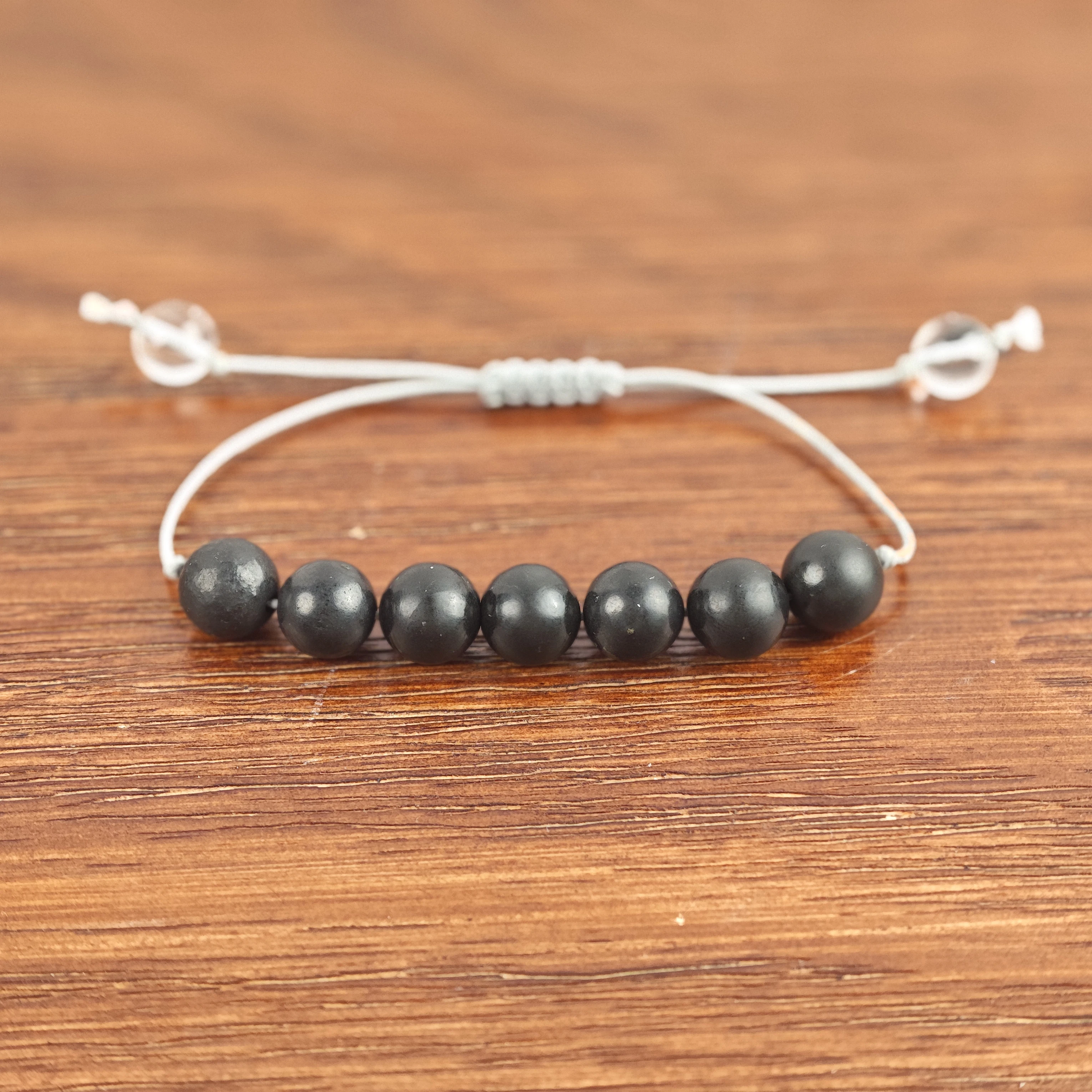 

Polished Shungite Beads Bracelet - Adjustable Cord with Clear Quartz Beads for Wellness and Spiritual Protection