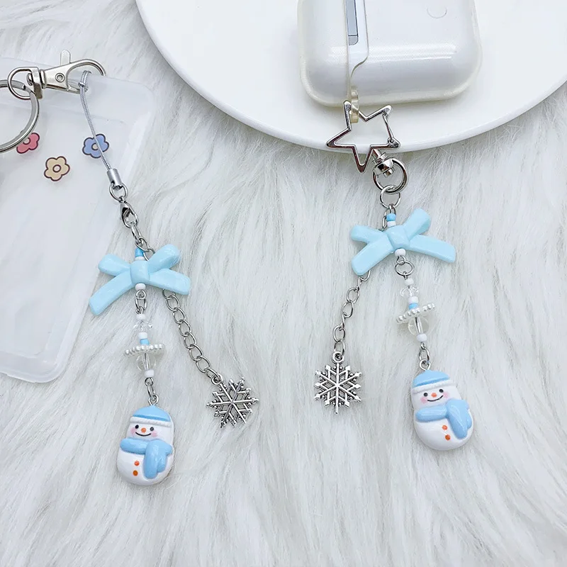 สายคล้องโทรศัพท์มือถือลายการ์ตูนน่ารัก รูปเกล็ดหิมะและตุ๊กตาหิมะ สำหรับฤดูหนาว  แบบหวานๆ อเนกประสงค์ เหมาะสำหรับสาวๆ แฟนสาว  ใช้คล้องกระเป๋าได้