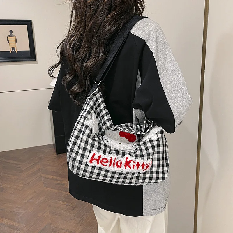 

Hello Kitty cute soft plaid shoulder bag female cartoon large capacity crossbody canvas bag student class daily commuting bag