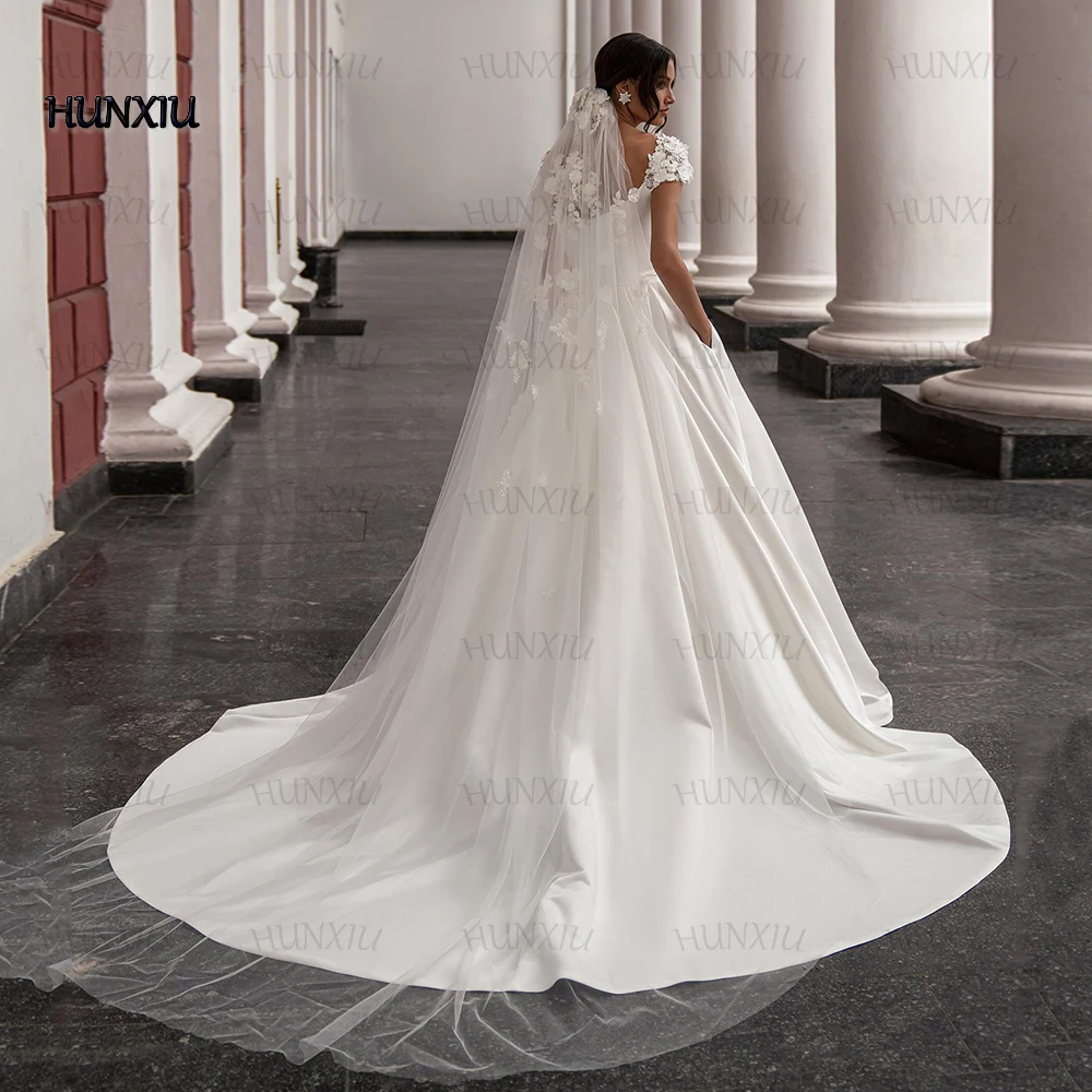 Vestido de boda de satén de lujo con flores estereoscópicas y mangas de casquillo, vestidos de princesa para novia, vestido de boda con bolsillo, túnica larga hasta el suelo