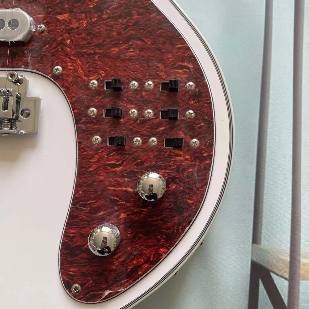 Pearl white electric guitar with three single-coil pickups and a red pickguard