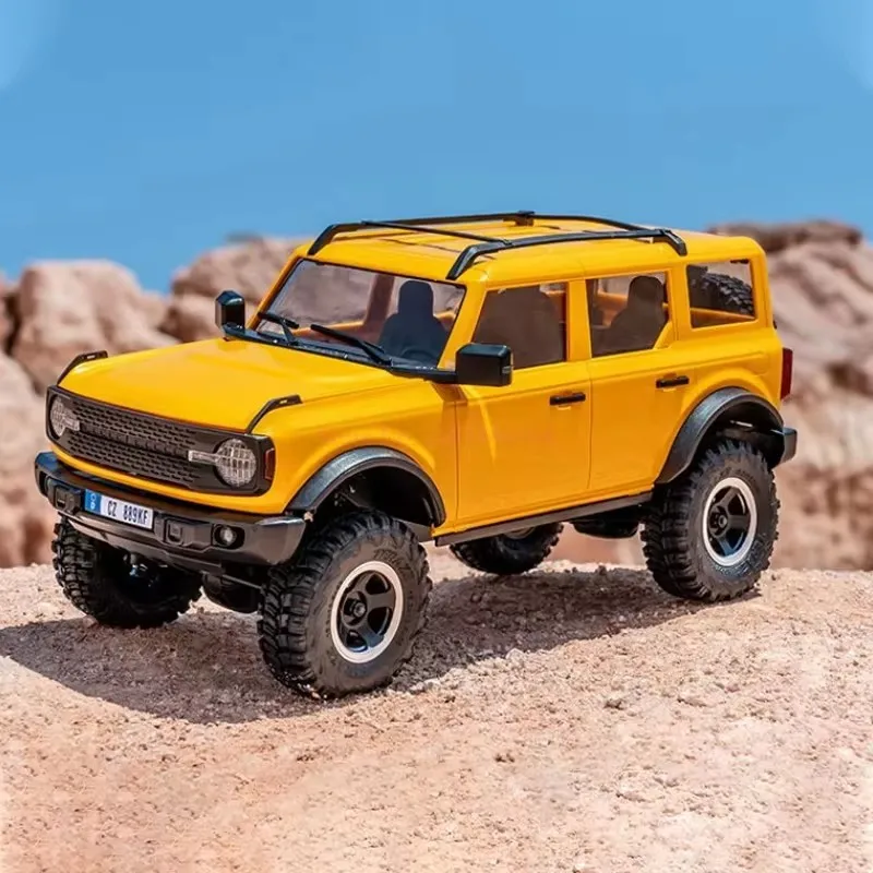 ของเล่นโมเดลจำลองเปลือกแข็งรถสำหรับปีนเขาทางวิบากแบบ FMS 1/18 Bronx Gold Rush Ford Wrangler mobil REMOTE CONTROL