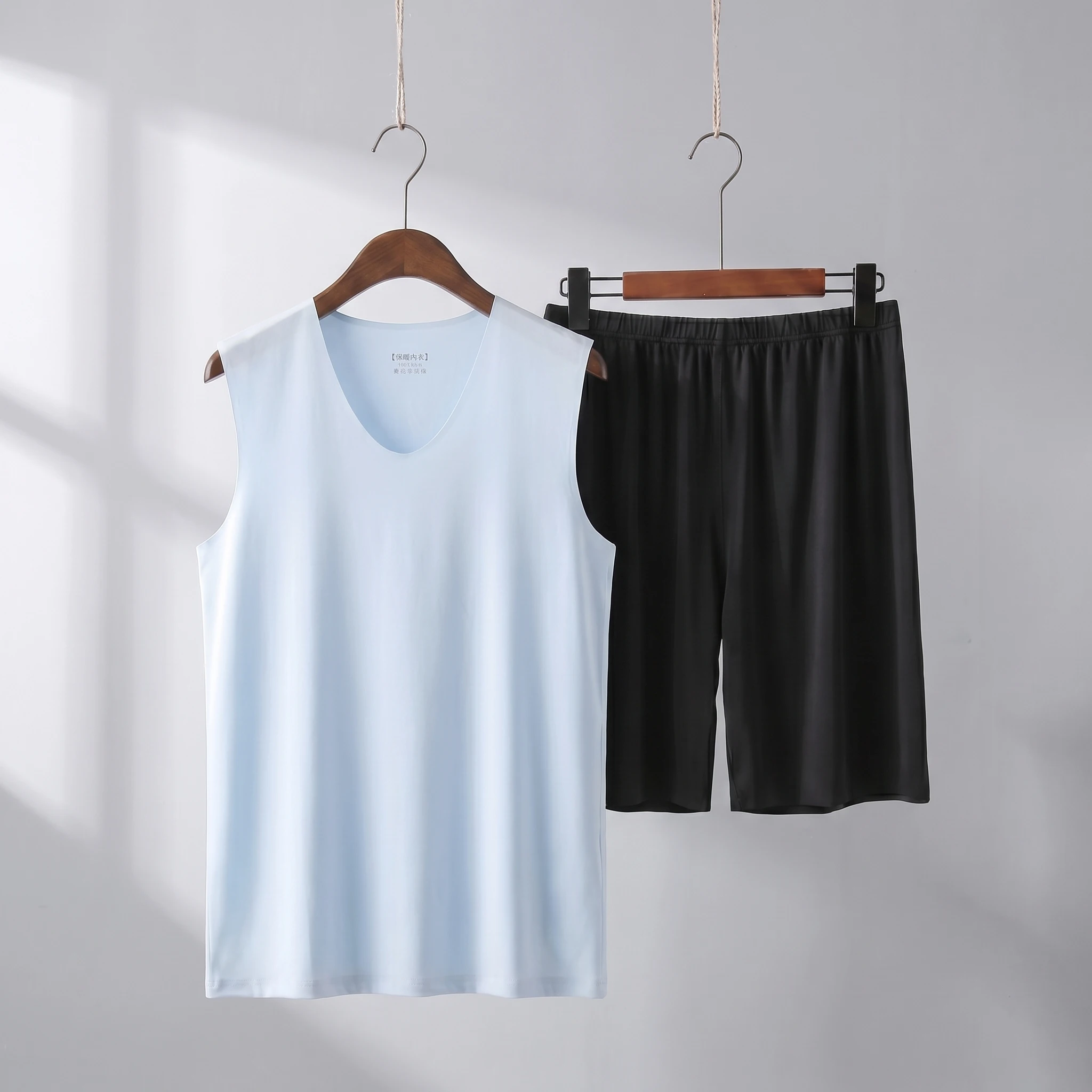 Light blue vest + black shorts