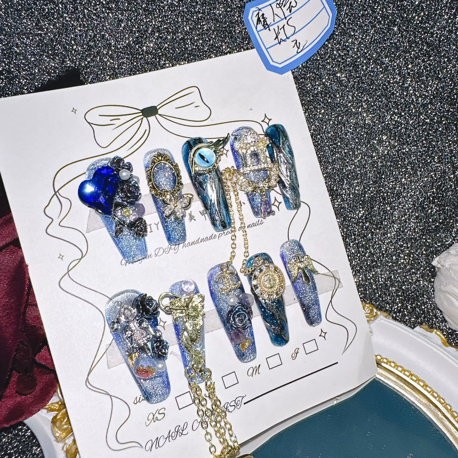 

Mysterious Cosmic Blue Luxury 3D Press On Nails Glitter Base Metal Chain Multiple Sizes Gem Cluster Gold Accent Blue Glitter