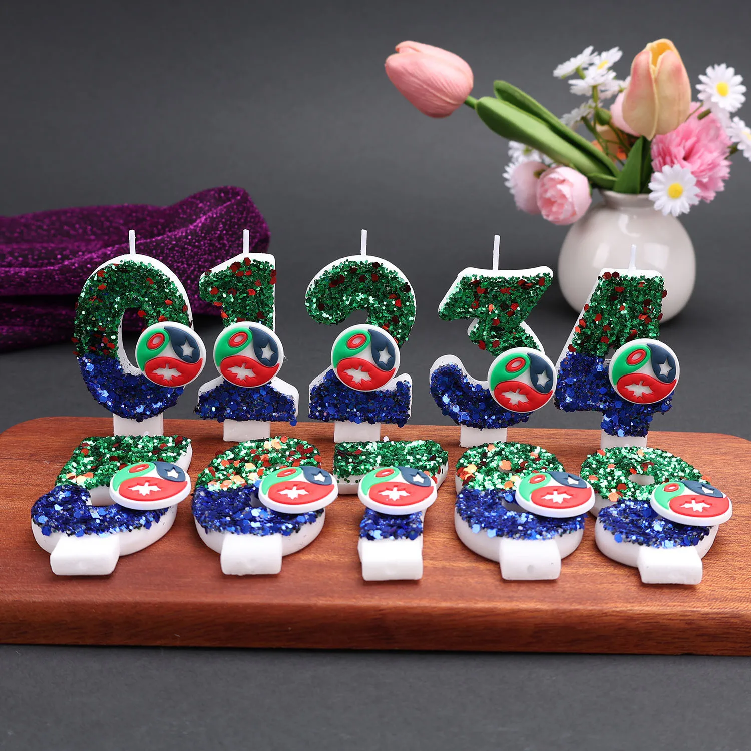 Green and blue digital candles with cartoon circular badges as decorations. Party gifts, birthday and anniversary candles.