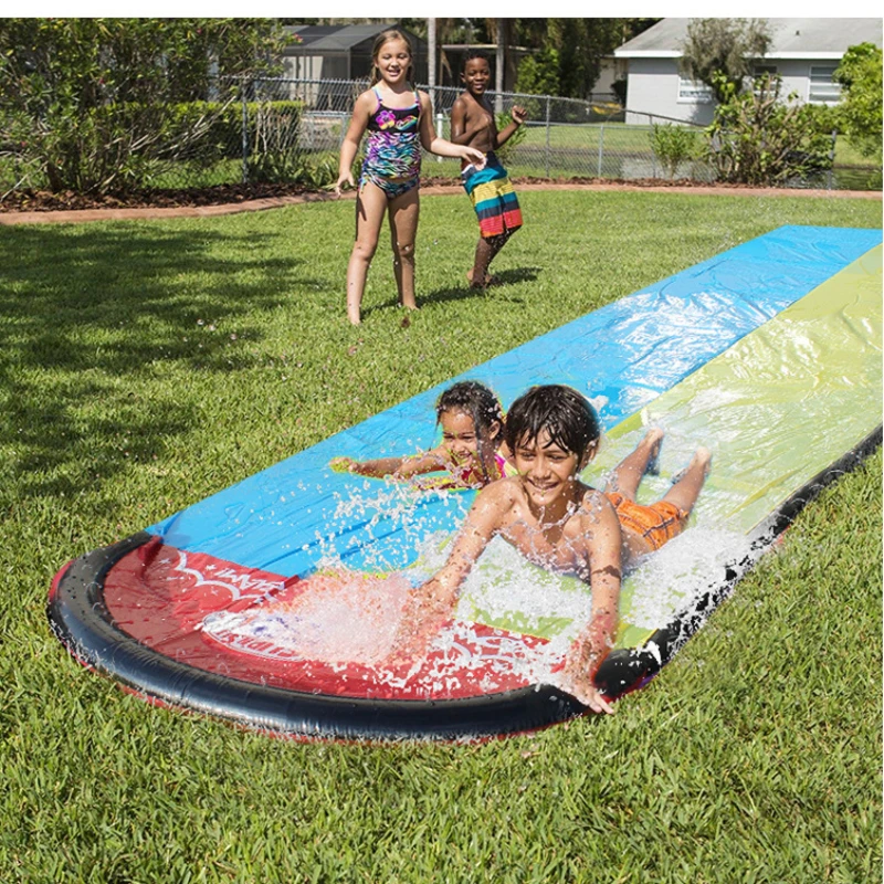 Children Play with Water Toys and Water Skiing Watercourses in Summer Children Play with Water in the Lawn Courtyard in Pairs