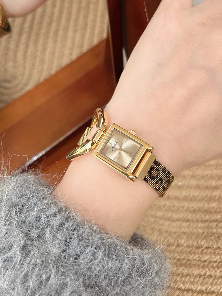 

Elegant women's watch with a large bezel design, square dial, leopard print magnetic strap, and a stylish, sophisticated look.