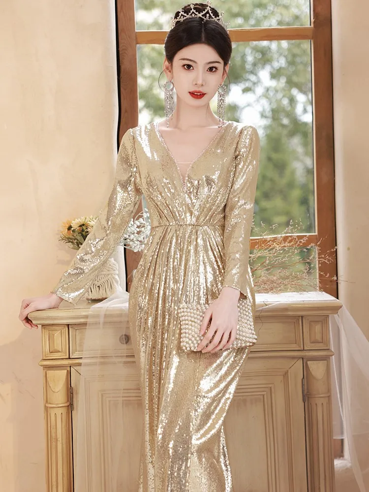 

The host of banquet wore a light luxurious golden and shiny dress with fishtail