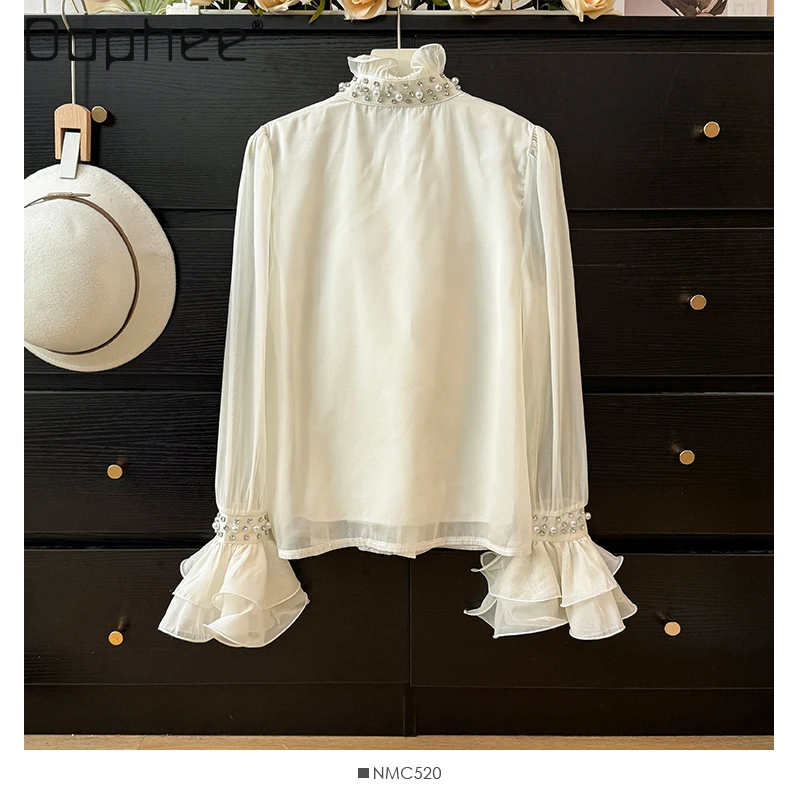 Camisa de manga acampanada con cuello levantado y perlas de gama alta de estilo francés para mujer otoño 2025 Top elegante de moda con una sola botonadura