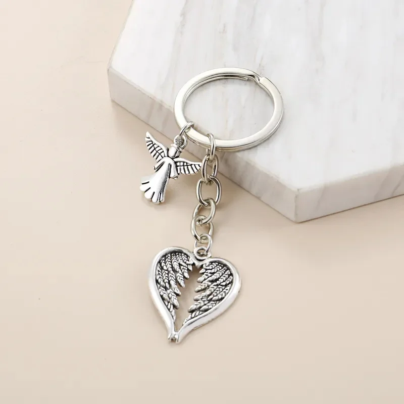 سلسلة مفاتيح Fashion Guardian Angel بتصميم أجنحة على شكل قلب، خفيفة وذكية، يمكن تعليقها على حقائب اليد