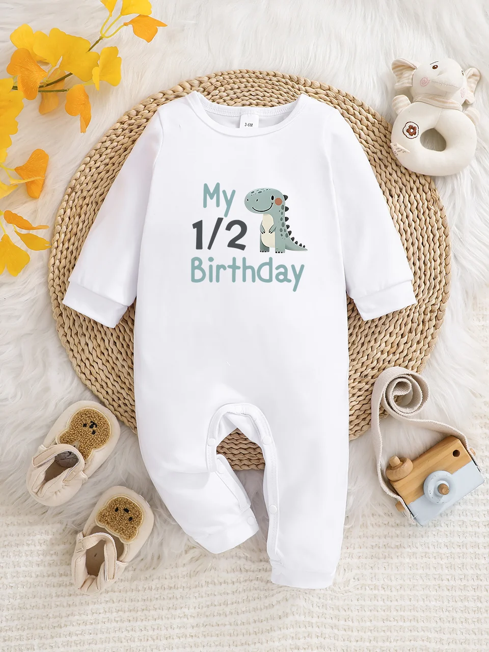 A baby long-sleeved onesie with interesting letter prints. It features a buttoned design for easy putting on and taking off, and