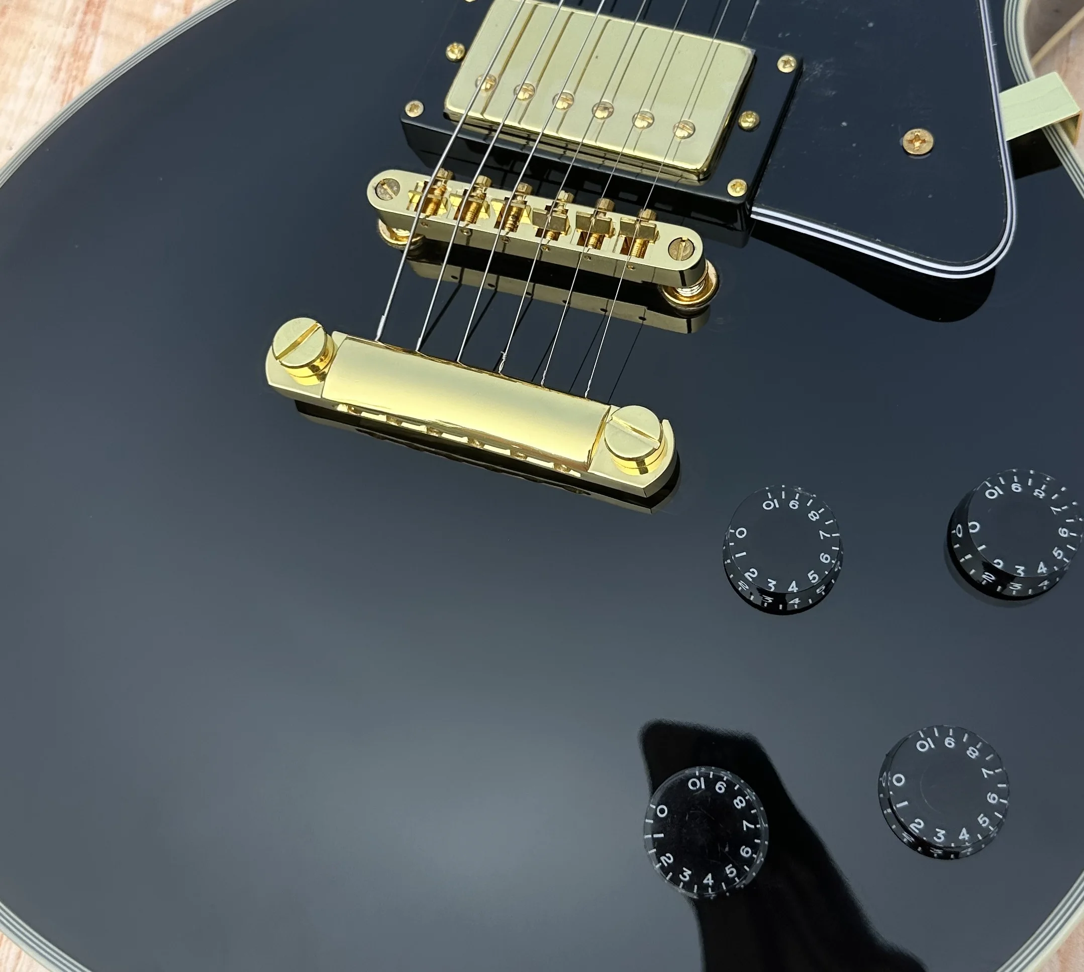 Customized electric guitar, black caston,  Imported wood,gold accessories, lightning package