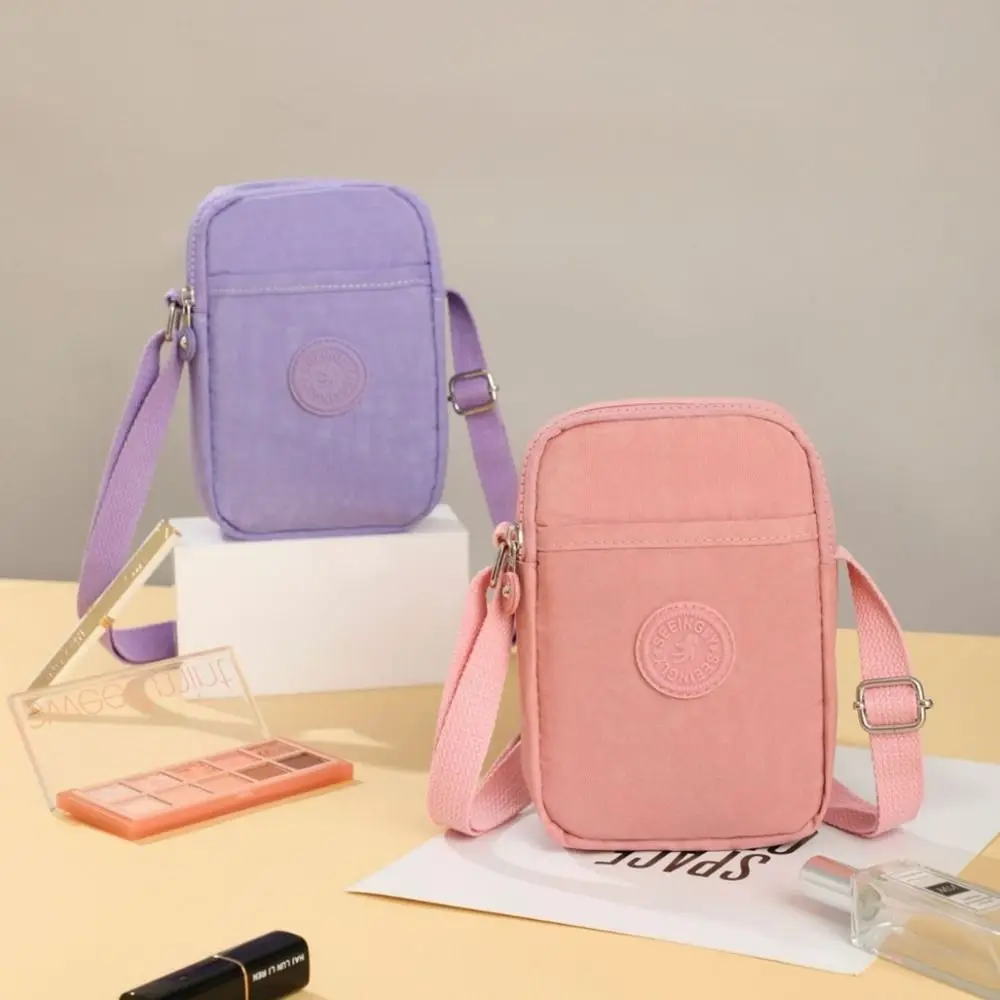 حقيبة كروس محمولة متعددة الوظائف بسحاب بتصميم متخصص حقيبة كتف من النايلون بلون سادة على الطراز الكوري حقيبة هاتف صغيرة للنساء #1