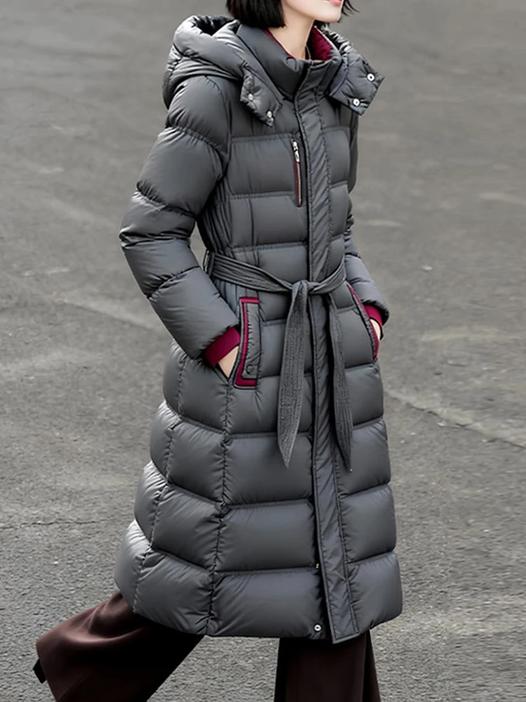 Elegant Long down jacket with hooded women's 2026 Winter High quality warm puffer coat with sashes Female outwear INKEO DJ640