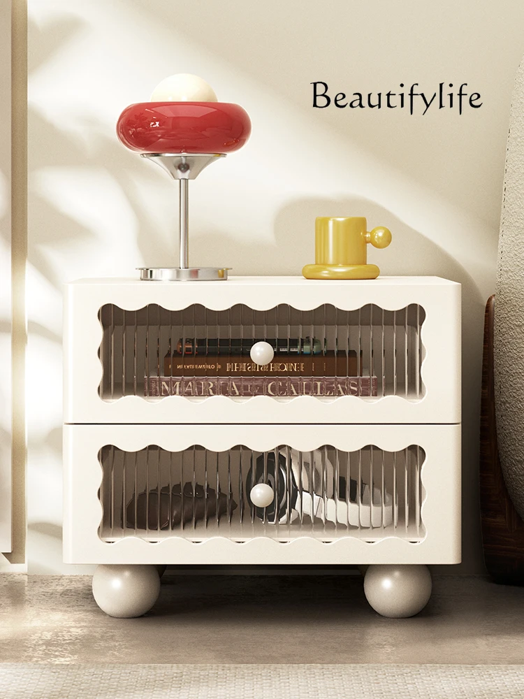 

Cream wind bedside table simple modern small apartment French bedroom with glass black high-end bedside storage cabinet