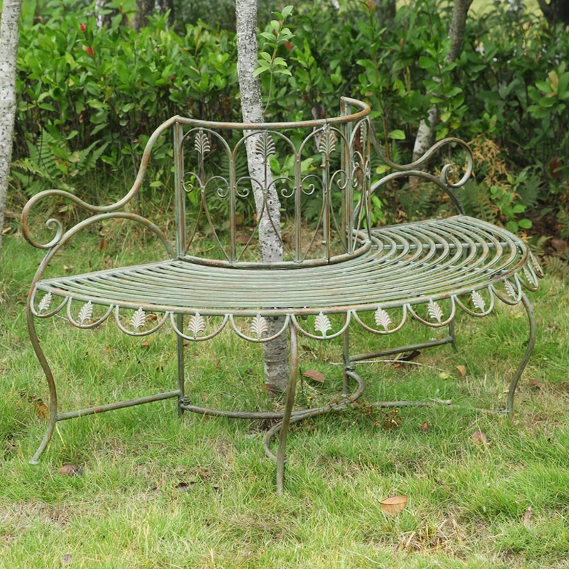 

Outdoor garden wrought iron tree chair backed by garden villa courtyard chair