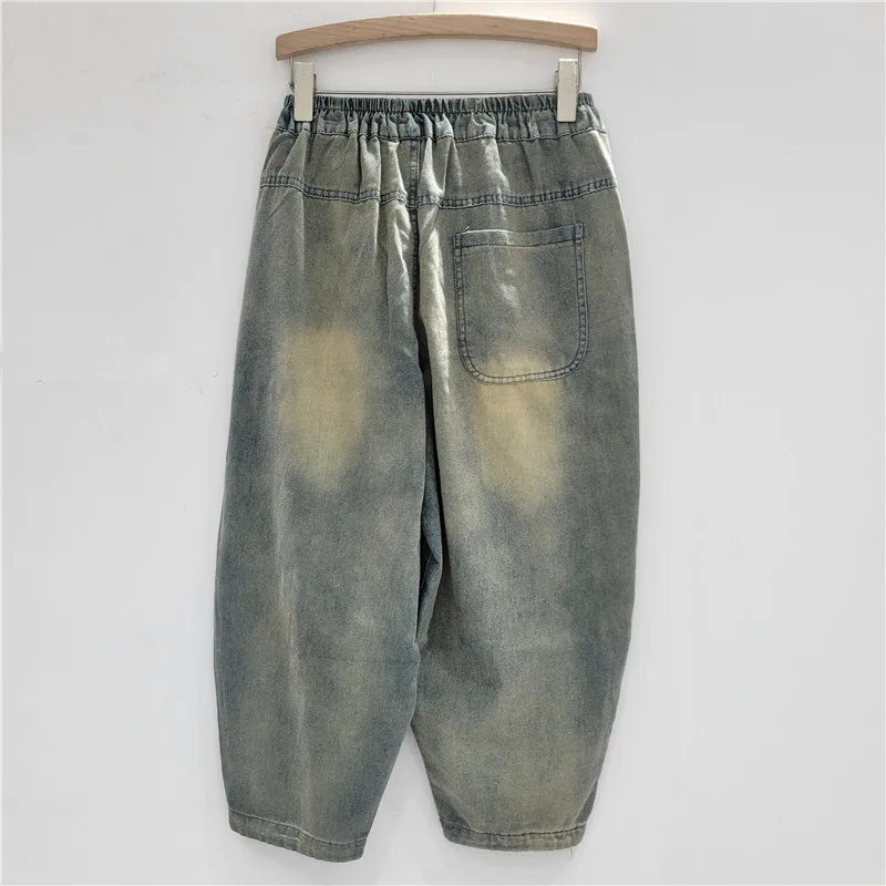 

Vintage relaxed-fit jeans featuring artistic graffiti letter prints and edgy ripped details for a unique, streetwise look.