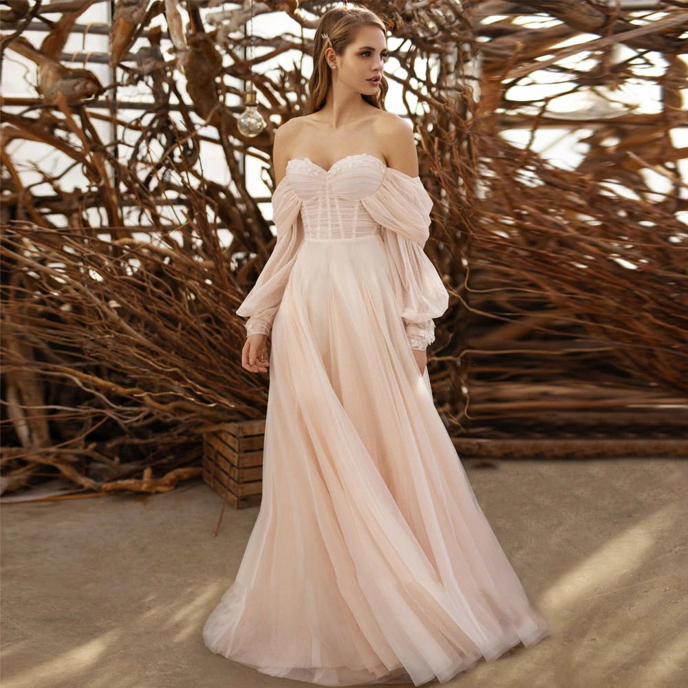 Suknie ślubne z tiulu w kolorze pudrowego różu, odpinane bufiaste długie rękawy, aplikacje, plisowane suknie ślubne z odkrytymi ramionami w stylu boho, kolekcja 2026