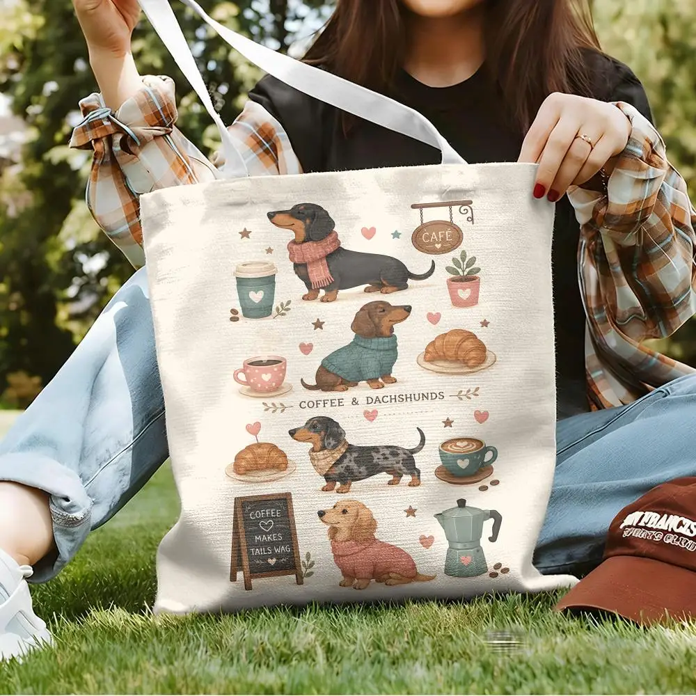Aesthetic beige canvas tote bag with colorful cartoon dachshund dog illustrations hanging on a wooden rack next to a cozy home setting.