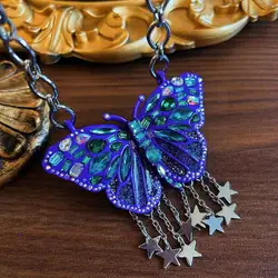 exaggerated butterfly necklace with blue tassels