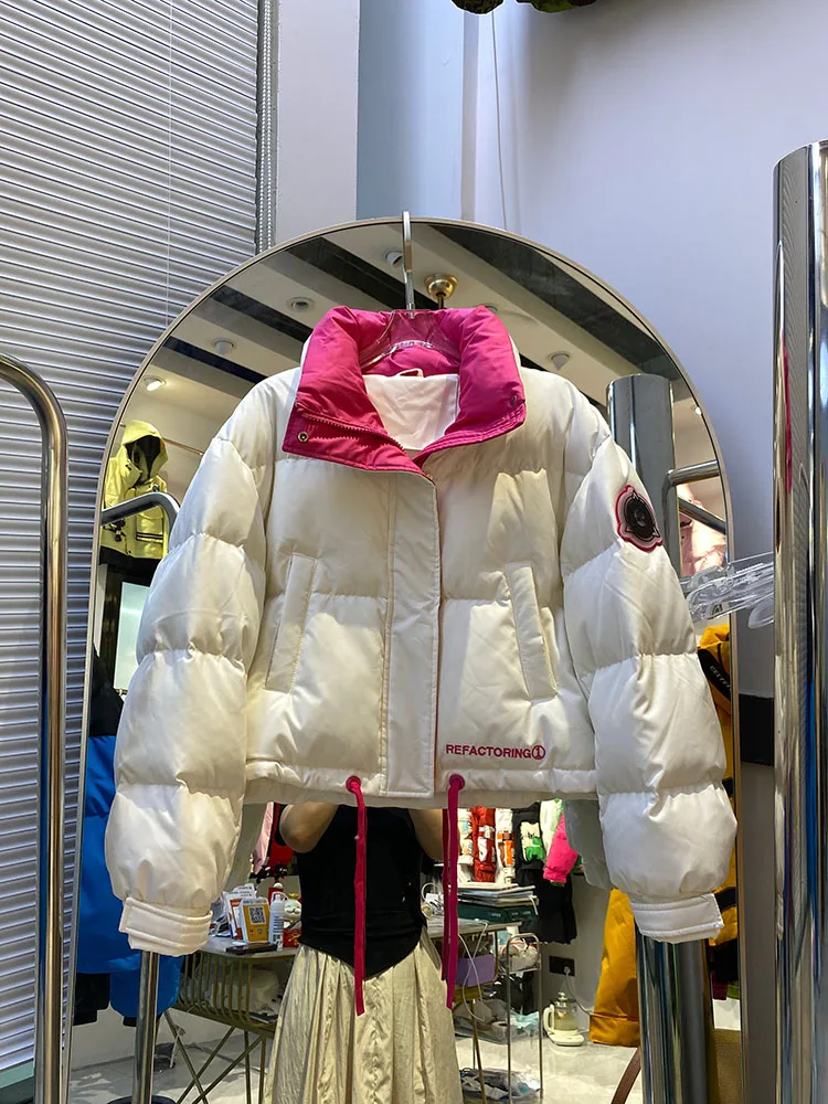 Chaqueta de plumón cálida con capucha para mujer, chaqueta de plumón de pato blanco a la moda con temperamento elegante, novedad de invierno de 2025