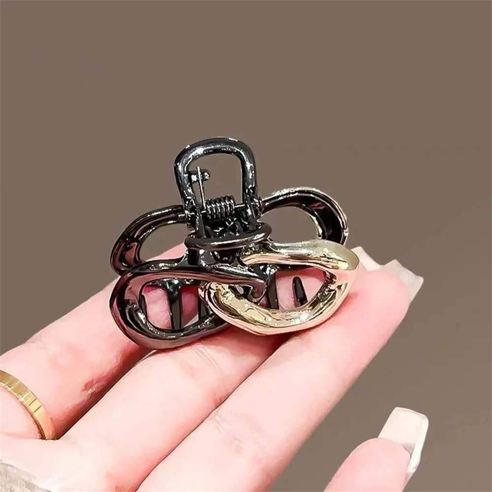 Small Hair Claw Clip Women Dual Interlocking Loop Design Glossy Black and Gold Plated Metal Alloy view 4
