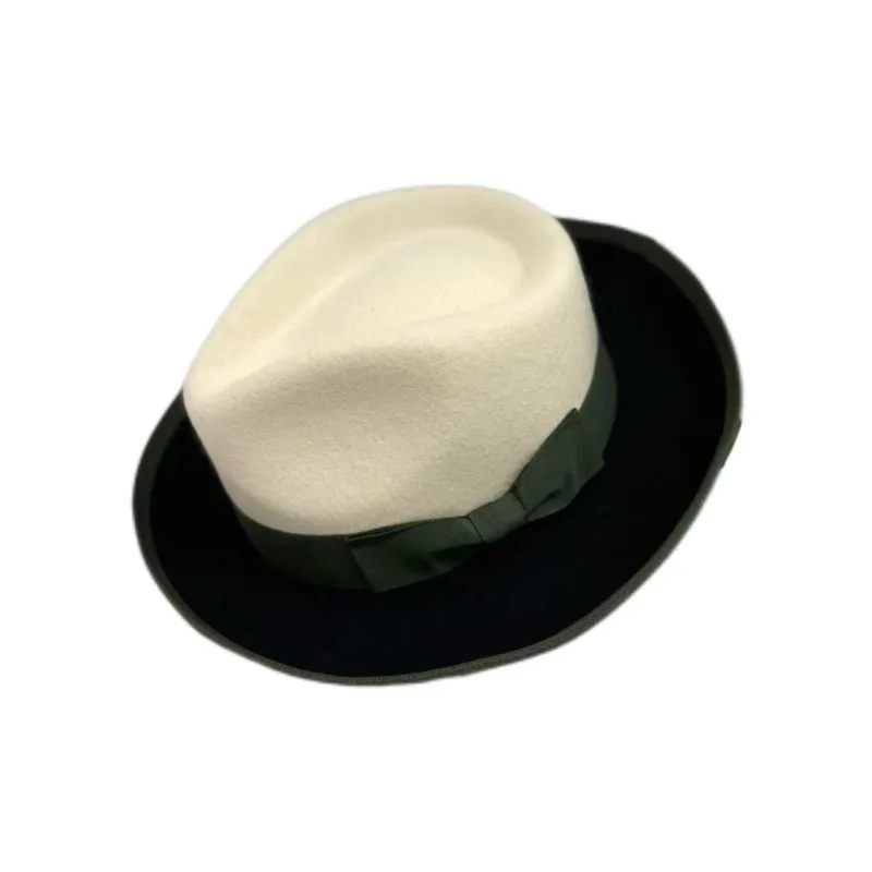A white and black patchwork top hat with knot decoration felt