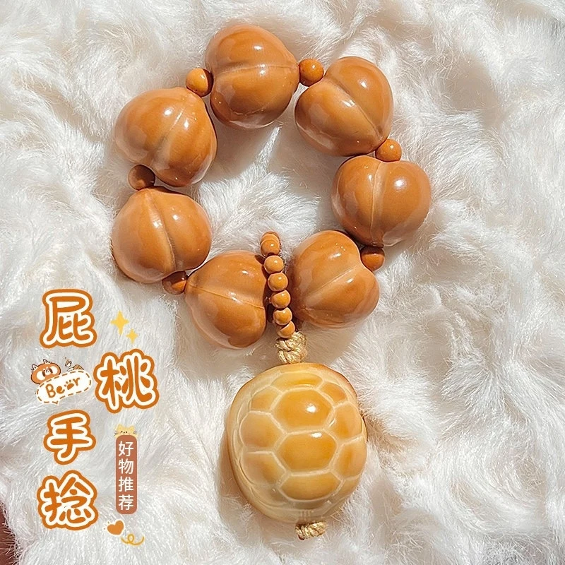 

Polished Heart-Shaped Peach Stone Monkey Hand-Twisted Buddhist Prayer Beads Bracelet
