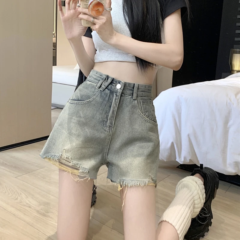 

Korean version of hundreds of worn holes denim shorts female new high-waisted nostalgia yellow thin a word denim hot trousers