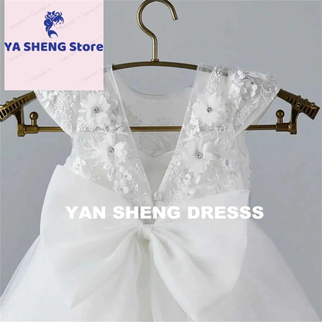 فستان فتاة الزهور من التول الأبيض مخصص مع فيونكة مزينة بدون أكمام لحفلات الزفاف وأعياد الميلاد وحفلات التواصل المقدس للفتيات